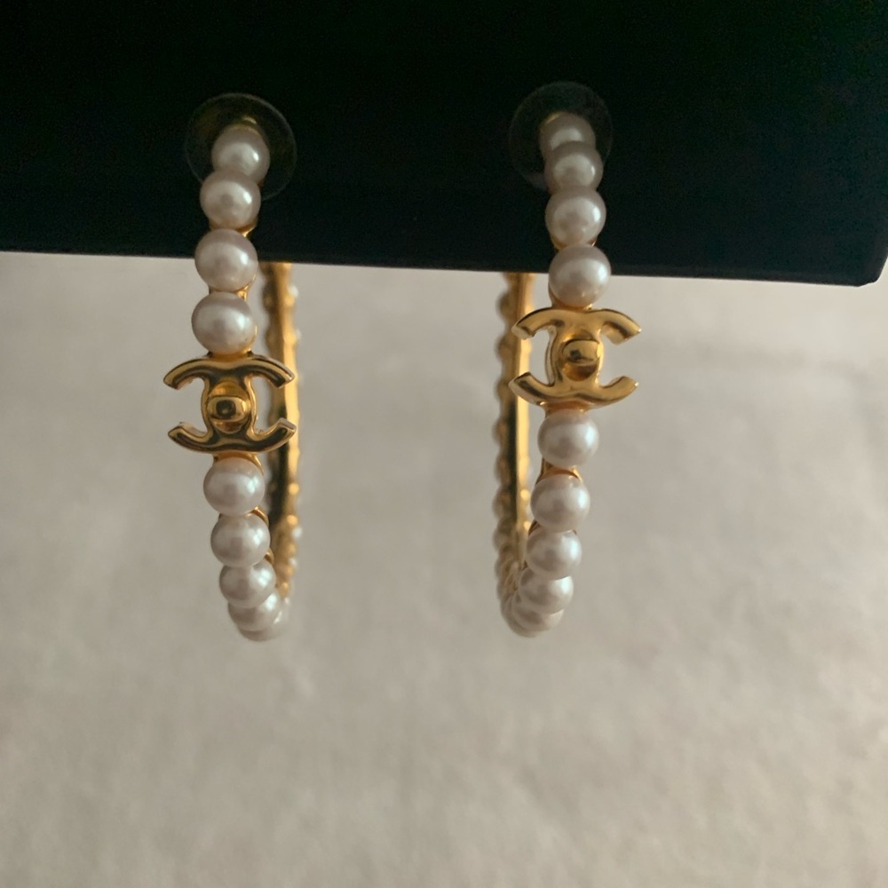 Chanel pearl hoops.